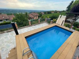 a swimming pool with a view of a house at Abbazia delle Sorelle in Novello