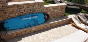 a surfboard sitting on top of a brick wall at Adriatic Queen in Gdinj