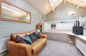 a living room with a couch in a room at River View in Buxton