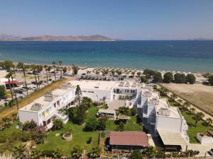 an aerial view of a large white house next to the ocean at Akti Dimis Hotel in Tigaki