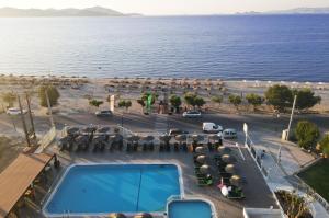 an aerial view of a resort with a swimming pool and the ocean at Akti Dimis Hotel in Tigaki