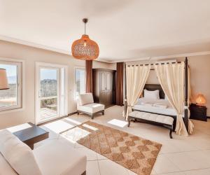 a bedroom with a bed and a couch and a table at Hill House Adult Only in Kaş