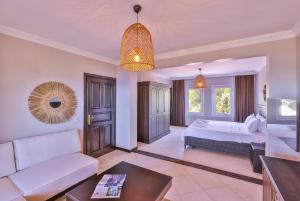a living room with a bed and a couch at Hill House Adult Only in Kaş