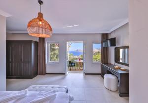 a living room with a bed and a dining room at Hill House Adult Only in Kaş