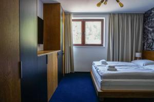 Postel nebo postele na pokoji v ubytování Apartmány Sport & Ski