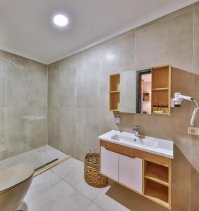 a bathroom with a sink and a toilet at Hill House Adult Only in Kaş