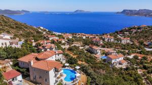 an aerial view of a village on a hill next to the ocean at Hill House Adult Only in Kaş