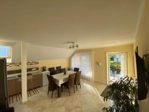 a kitchen and dining room with a table and chairs at Matyas Vendeghaz in Sovata
