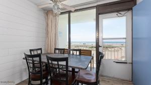a dining room with a table and chairs and a window at Beau Rivage Beach Resort in Wildwood Crest