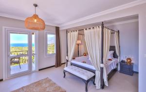 a bedroom with a canopy bed and a balcony at Hill House Adult Only in Kaş