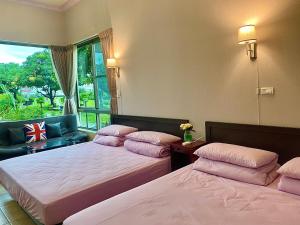 En eller flere senge i et værelse på Mei Nong Villa
