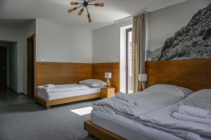 Postel nebo postele na pokoji v ubytování Apartmány Sport & Ski