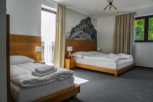 Postel nebo postele na pokoji v ubytování Apartmány Sport & Ski