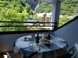 a table with a plate of food and bottles of wine at Apartamento Broto in Broto
