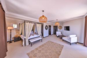a bedroom with a bed and a chair and a couch at Hill House Adult Only in Kaş