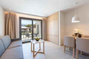 a living room with a couch and a table at Hipotels Barrosa Park in Chiclana de la Frontera