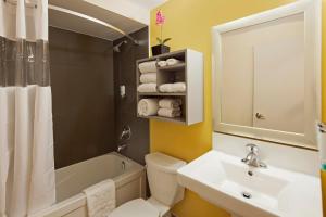 
a bathroom with a sink, toilet and shower at Canadas Best Value Inn Toronto in Toronto
