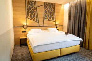 Säng eller sängar i ett rum på Amenity Hotel & Resort Orlické hory
