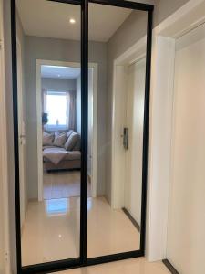 a mirror in a room with a living room at Notodden Sentrum Apartment NO 4 in Notodden
