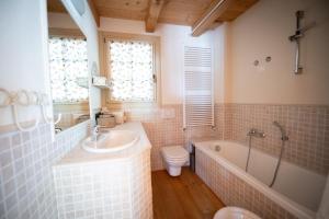 a bathroom with a sink and a tub and a toilet at TRILOCALE ALPES: DIMENTICA L'AUTO E RILASSATI in Ponte di Legno