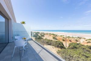 a balcony with a view of the beach at Hipotels Barrosa Park in Chiclana de la Frontera