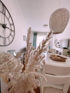 a living room with a large clock on the wall at Aska Apartment in Bar