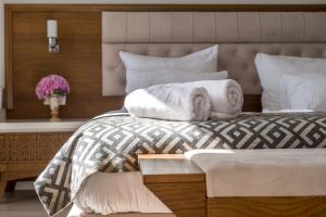 a bedroom with a bed with towels on it at Hotel Adrović in Sveti Stefan