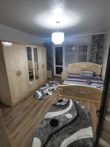 a bedroom with two beds and a rug at Apartament Central Băile Herculane in Băile Herculane