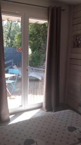 a bedroom with a door open to a patio at CHALETS Climatisés in Salernes +20 photos