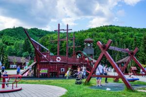 a playground in a park with people playing at Penzión DEER in Valča