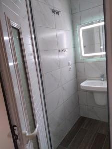 a bathroom with a shower and a sink at Condo Rooms in Sarandë