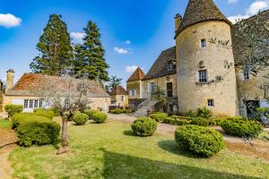 een oud kasteel met een tuin ervoor bij Villa avec piscine sur le domaine d'un château in Carsac-Aillac