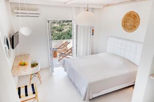 A bed or beds in a room at Faros Resort