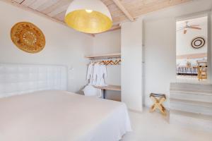 A bed or beds in a room at Faros Resort