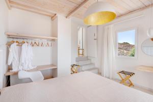 A bed or beds in a room at Faros Resort