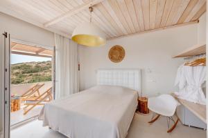 A bed or beds in a room at Faros Resort