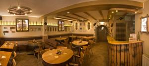 a restaurant with wooden tables and chairs and a bar at Gästehaus Manfred Christoffel in Kröv