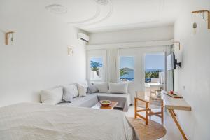 A bed or beds in a room at Faros Resort