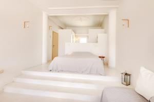 A bed or beds in a room at Faros Resort
