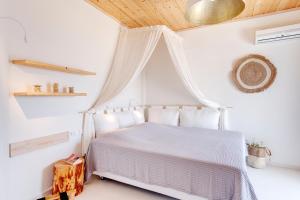 A bed or beds in a room at Faros Resort