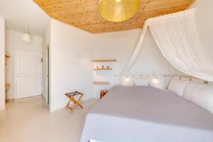 A bed or beds in a room at Faros Resort