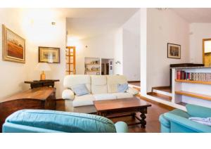 una sala de estar con un sofá y una mesa en Casa vacanze a pochi passi dal mare, en La Maddalena