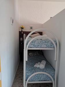 a small bedroom with a bunk bed with towels on it at Baby House in Castel di Tusa