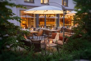 a restaurant with tables and chairs and an umbrella at Acasa Suites in Zurich