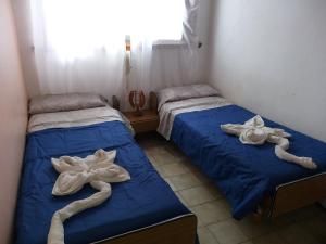 2 camas con toallas en una habitación en Hotel Drumond en San Bernardo