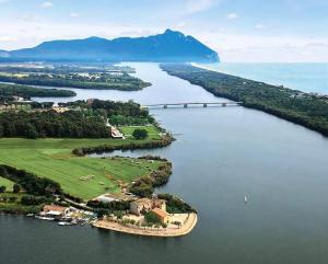 an island in the middle of a lake with a bridge at Casale Del Borgo in Hermada