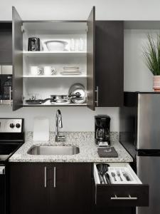 a kitchen with a sink and a counter at stayAPT Suites Raleigh-Durham/RTP in Durham
