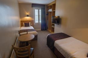 Ένα ή περισσότερα κρεβάτια σε δωμάτιο στο The Carraig Hotel
