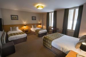 Ένα ή περισσότερα κρεβάτια σε δωμάτιο στο The Carraig Hotel