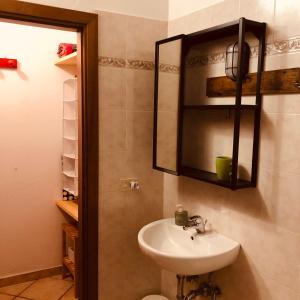 a bathroom with a sink and a mirror at Anitta GuestHouse in Castagneto Carducci